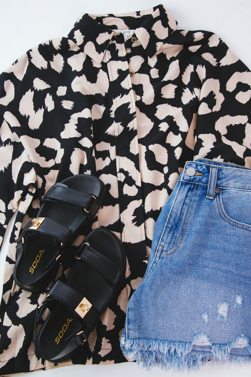 Black blouse with cream leopard print pattern featured with denim shorts and black sandals