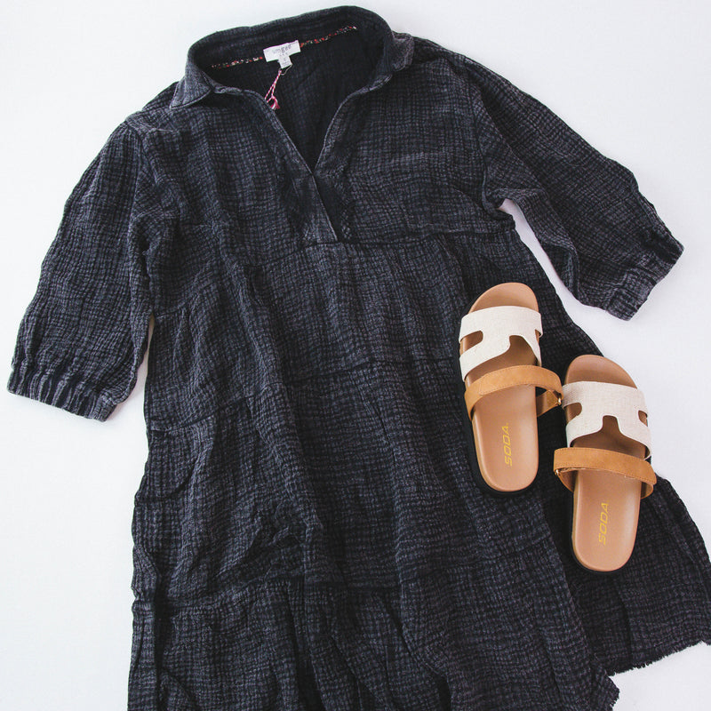 Black mineral wash dress paired with cream neutral sandals on a white backdrop