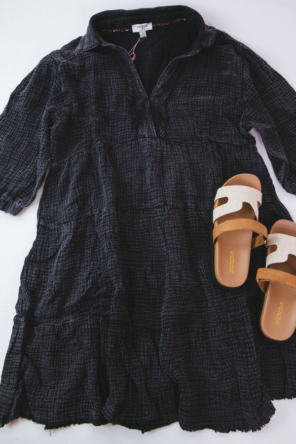 Black mineral wash dress paired with cream neutral sandals on a white backdrop