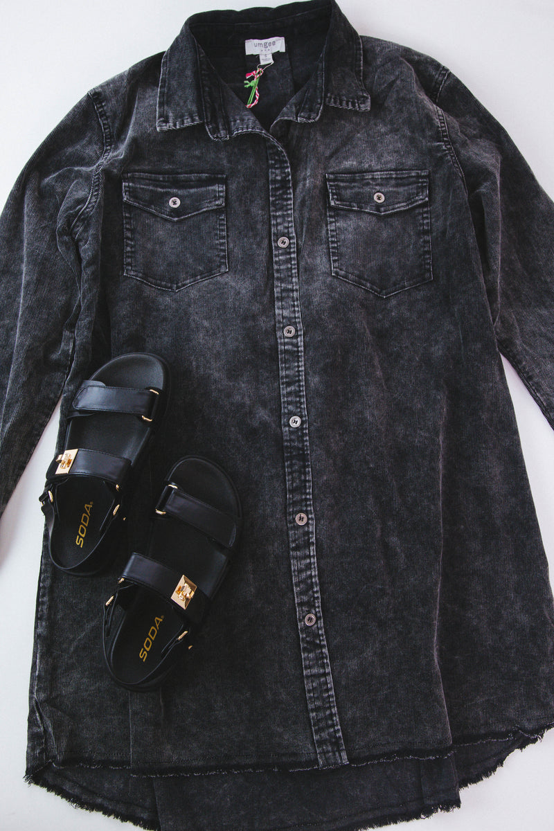 Stone wash button down denim dress in Ash color paired with black sandals on a white background